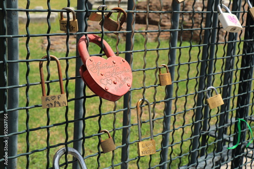 Locks hanging on the fence photo