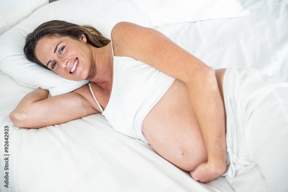 High angle view of happy woman on bed High angle view of happy woman on bed