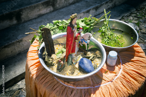 Leaves infused with sacred water wait on a table for use in candomble axé blessings in the tourist center of Pelourinho, Salvador, Bahia, Brazil photo