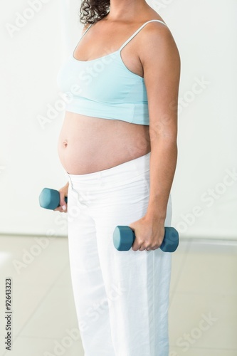 Pregnant woman lifting weights