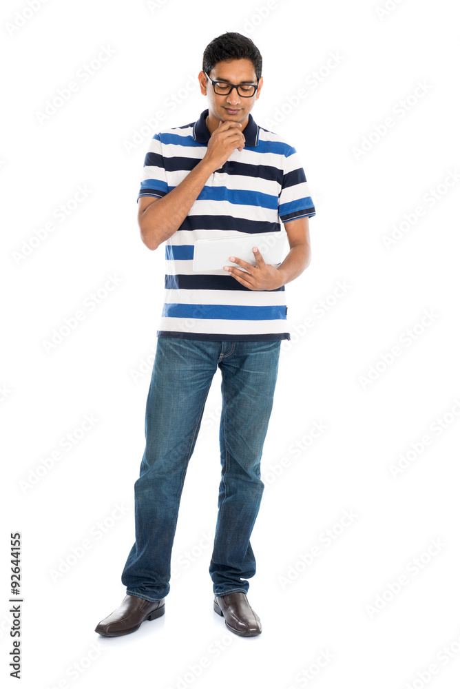 Happy young man using digital tablet against white background. Happy young man using digital tablet against white background.