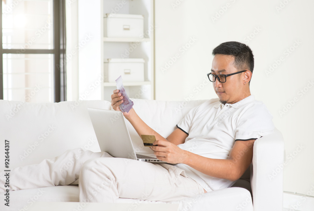 asian man earning cash from Internet asian man earning cash from Internet