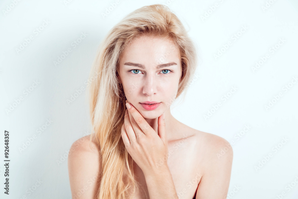 Beautiful blond with green eyes on a light background. She looks into the camera. Fashionable hair color. A good manicure. Beautiful blond with green eyes on a light background. She looks into the camera. Fashionable hair color. A good manicure.