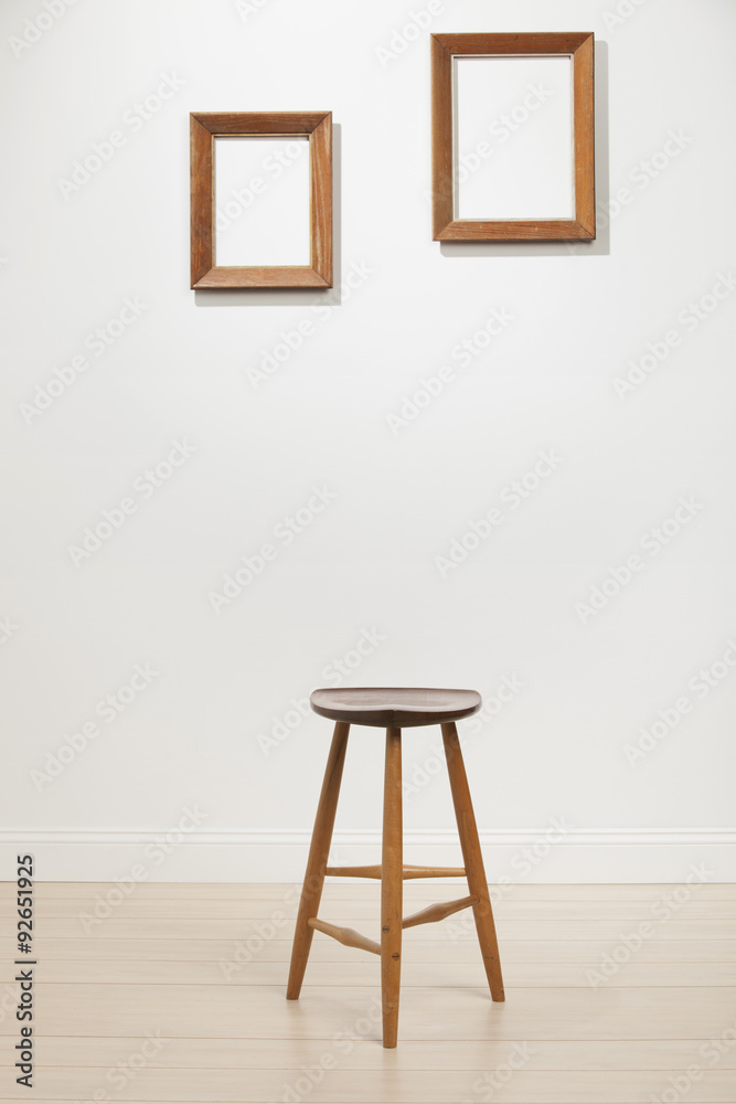 empty frames and chair on a white wall, interior empty frames and chair on a white wall, interior