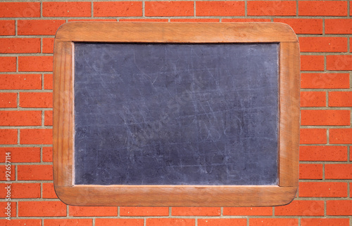 School blackboard over brick wall background