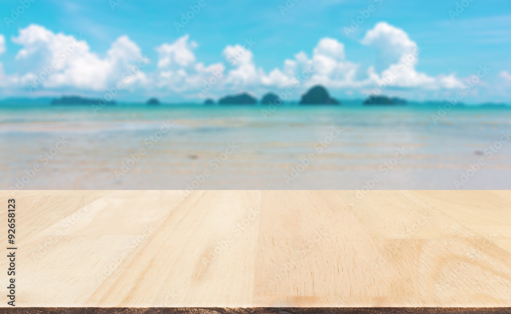 Fototapeta premium Wood table top on blured sea and sky : Can use for montage or display your product.