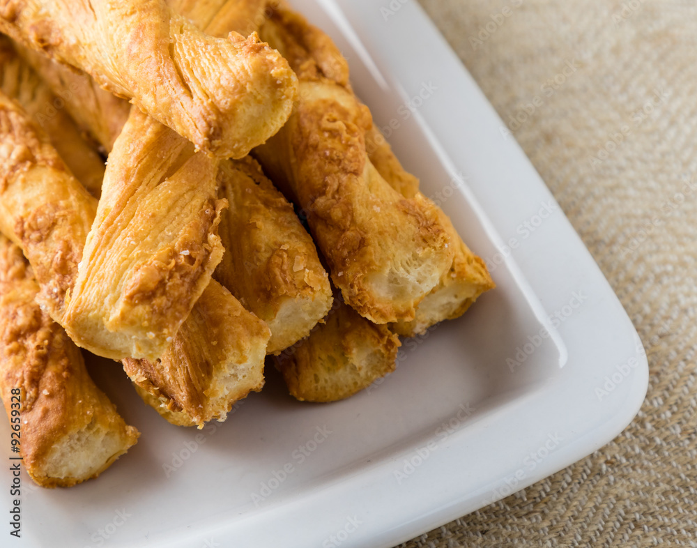 pastry sticks with cheese on white plate pastry sticks with cheese on white plate