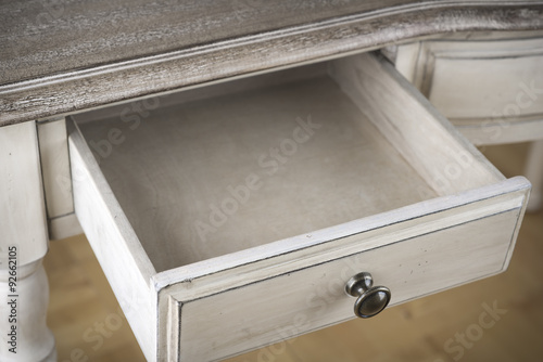 Canvas Print Open wooden drawer of vintage writting table