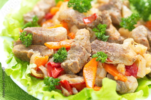 Warm salad with meat and fried vegetables