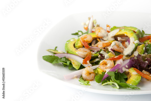 Salad with avocado and shrimp on the white background horizontal