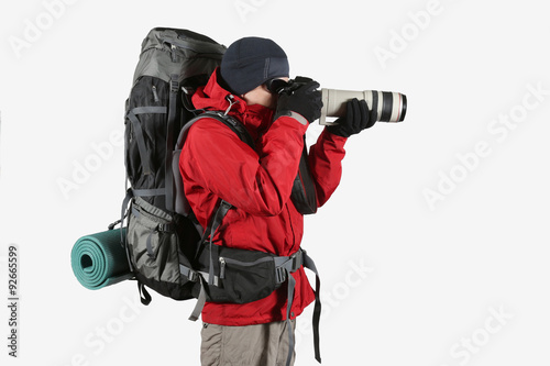 a tourist in a red jacket with a gray backpack on a white backgr