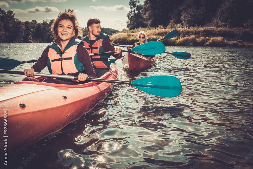 Group of happy people on a kayaks