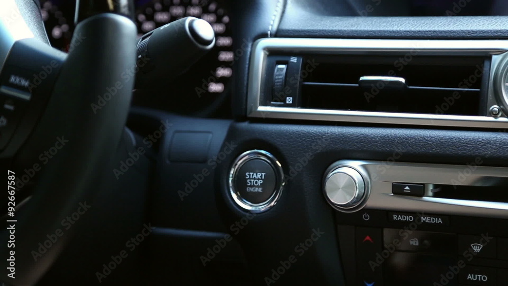 The man starts the car engine with the button start-stop-engine
The man starts the car engine with the button start-stop-engine