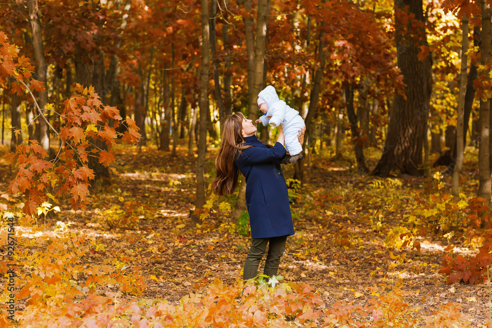 Happy young mother with little daughter in autumn park Happy young mother with little daughter in autumn park