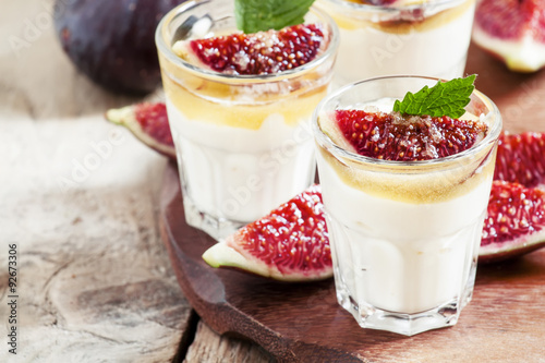 Creamy white yogurt with honey, figs and mint, selective focus