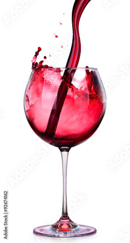 Glass of red wine with splashes isolated on a white 