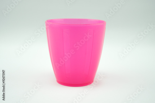pink plastic mug on white background