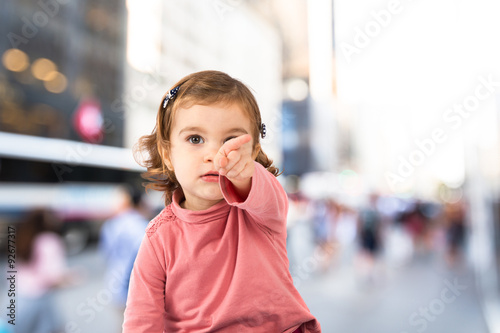 Cute baby pointing to the front over white background