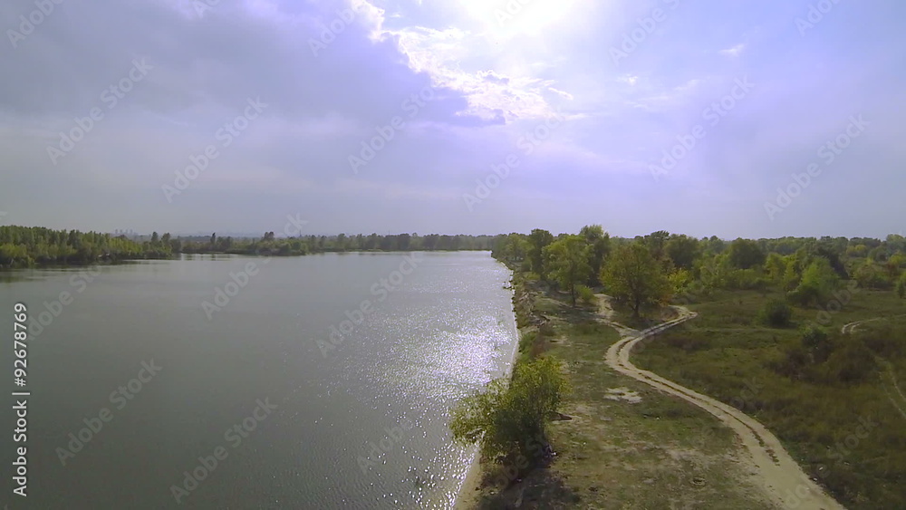 Smooth flight over river with reflections of sunshine on water .Aerial
Smooth flight over river with reflections of sunshine on water .Aerial