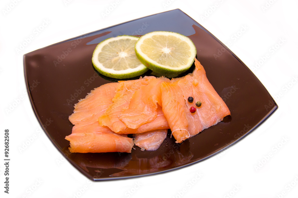 Smoked salmon on black plate on a white background Smoked salmon on black plate on a white background