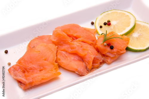 Smoked salmon on tray on white background seen close