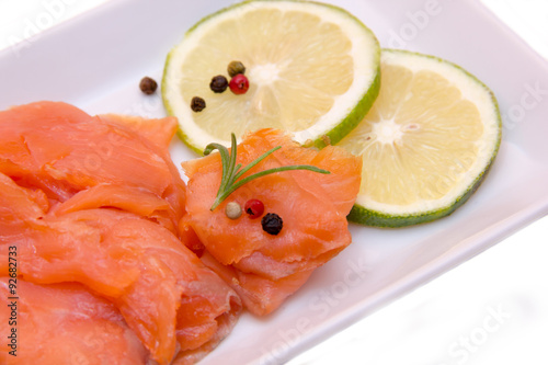 Smoked salmon on tray on white background seen from very close