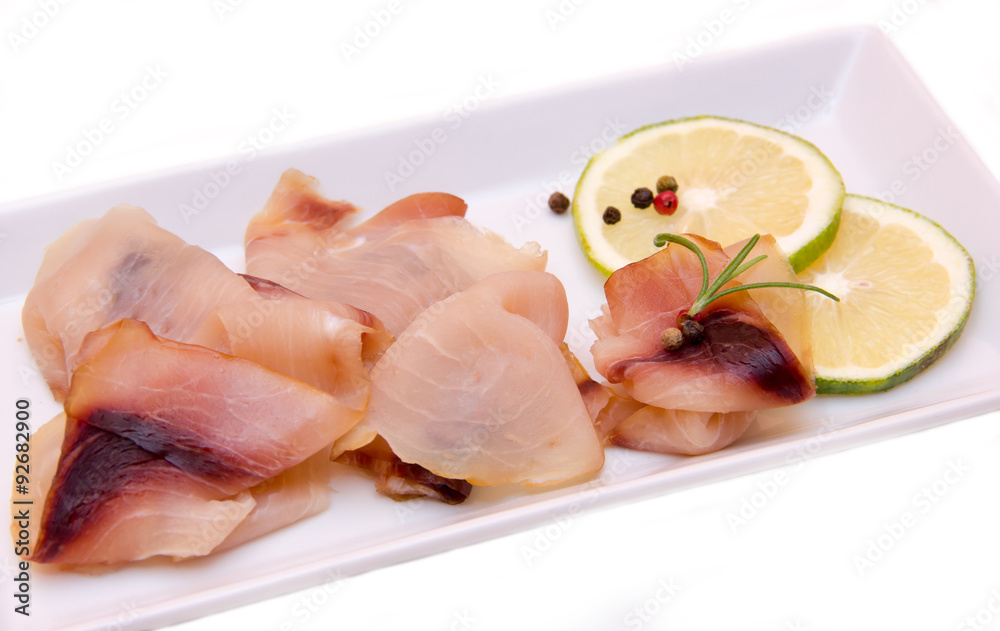Smoked swordfish on the tray on white background seen close