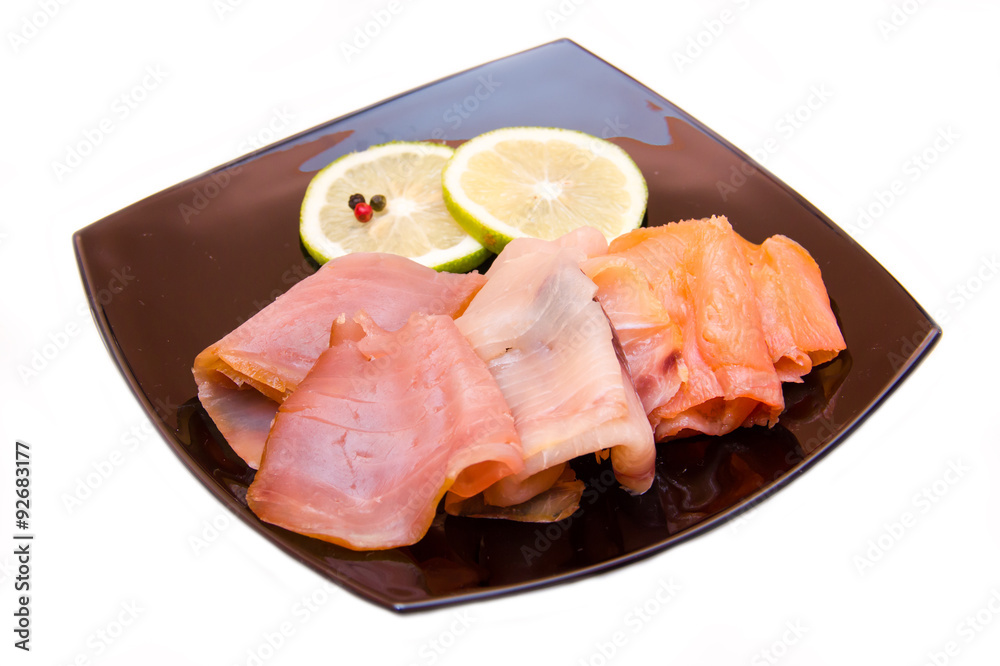 Trio of smoked fish on plate on white background Trio of smoked fish on plate on white background