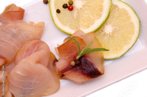 Smoked swordfish on the tray on white background seen from above and very close