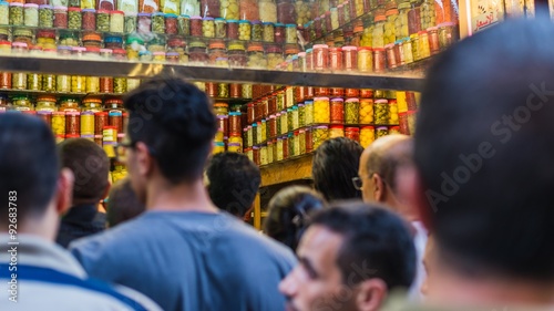defocused people standing in front of a shop in fes