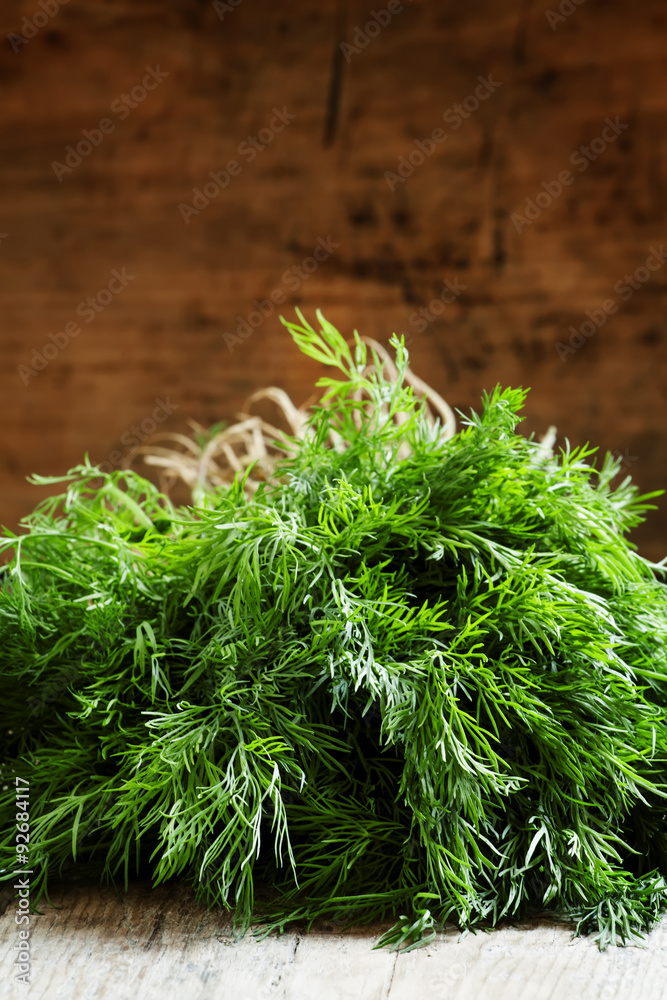 Fototapeta premium Fresh dill from the garden on the old wooden table in rustic sty