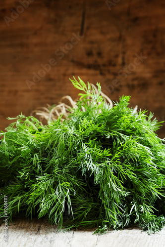 Fresh dill from the garden on the old wooden table in rustic sty