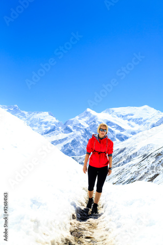 Woman walking in winter mountains, hiking inspiration