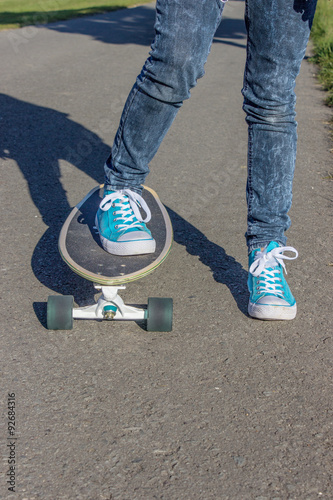Skateboard / Girl with blue shoes on a skateboard 