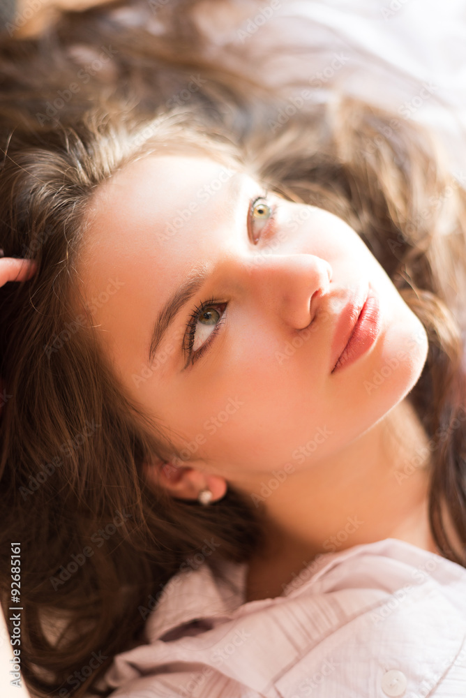 Picture of amazing charming girl lying in bed on blurred morning Picture of amazing charming girl lying in bed on blurred morning