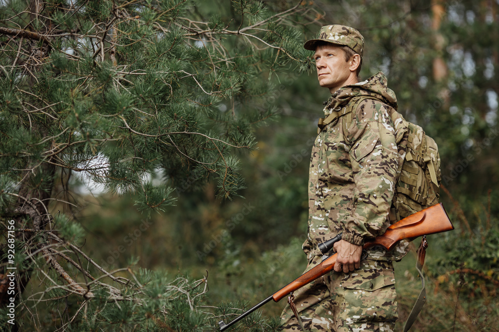 hunter in camouflage clothes ready to hunt with hunting rifle hunter in camouflage clothes ready to hunt with hunting rifle