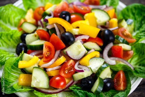 Fresh Close Up Vegetable Salad with, black olives, cherry tomatoes, yellow pepper, red onion, cucumber.