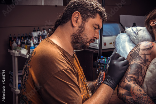 Master works in tattoo studio