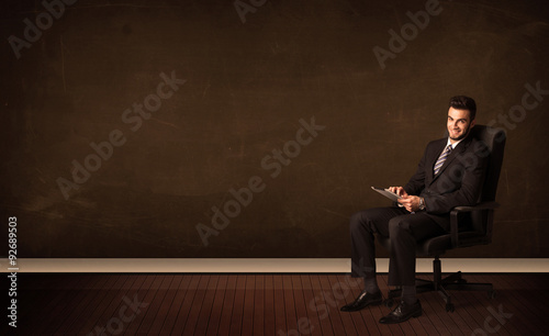 Businessman holding high tech tablet on background with copyspac