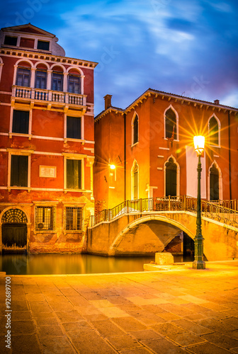 Narrow canal in Venice in the evening