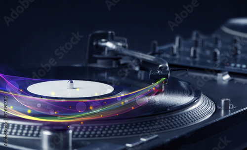 Turntable playing vinyl with glowing abstract lines