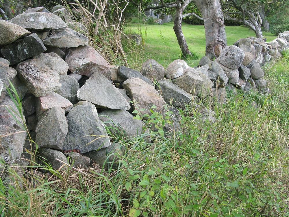 Traditional drystone wall as house boundary in Falkenberg, Sweden. Traditional drystone wall as house boundary in Falkenberg, Sweden.