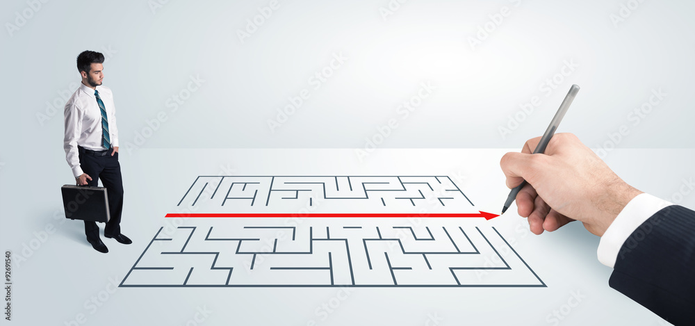 Business man looking at hand drawing solution for maze Business man looking at hand drawing solution for maze