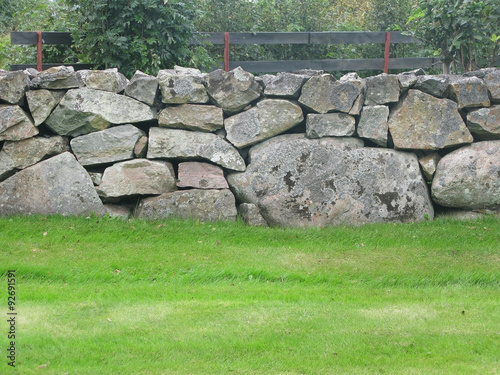 Traditional drystone wall fence as house boundary in Falkenberg, Sweden.