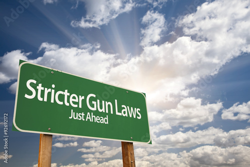 Fotografi Stricter Gun Laws Green Road Sign Over Clouds