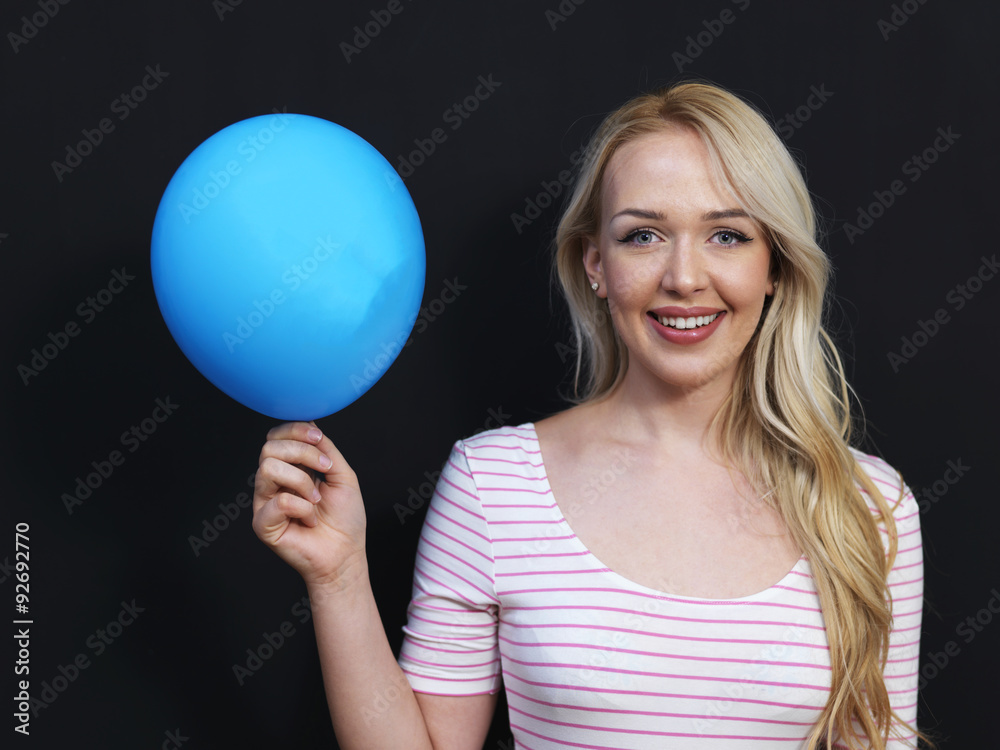 Caucasian woman standing in front of a dark chalkboard. The chal Caucasian woman standing in front of a dark chalkboard. The chal