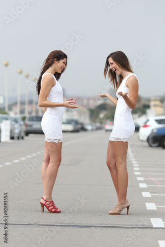 Happy women wearing the same dress