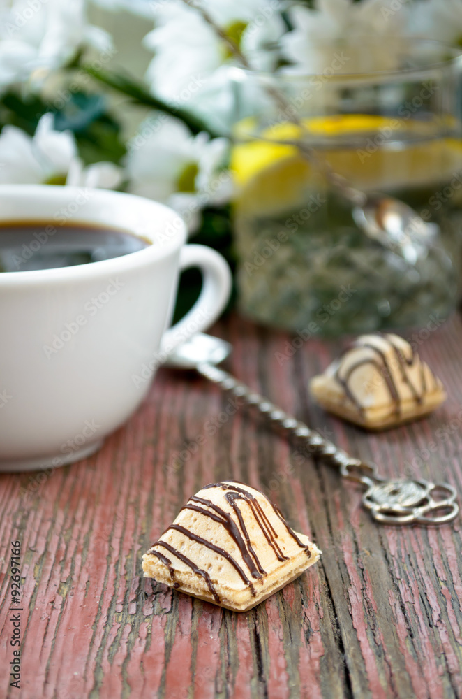 coffee with candies, lemon water and white flowers coffee with candies, lemon water and white flowers