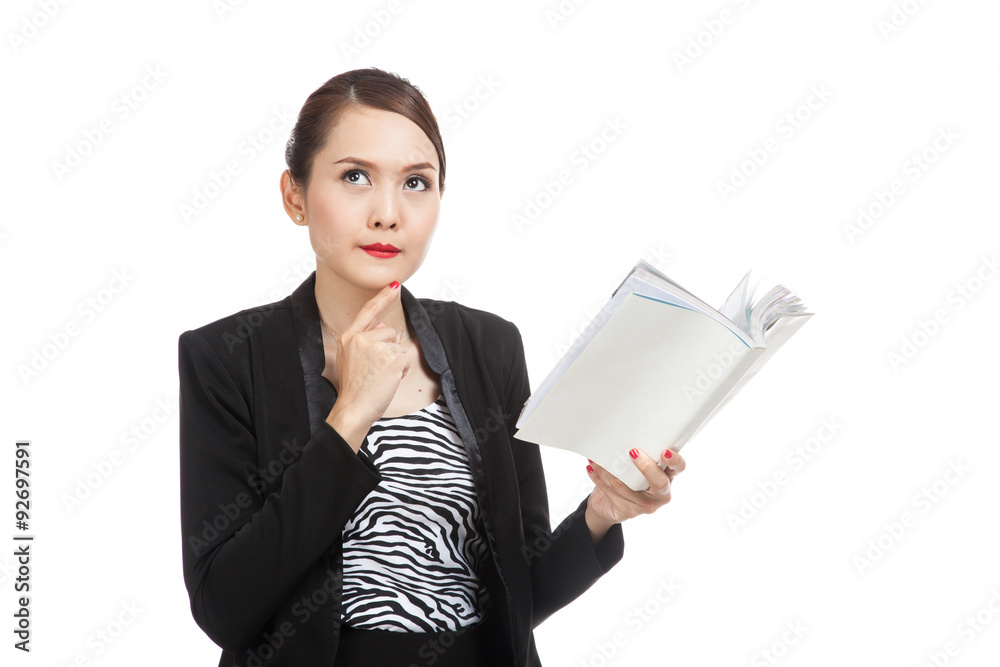 Young Asian business woman with a book is thinking Young Asian business woman with a book is thinking