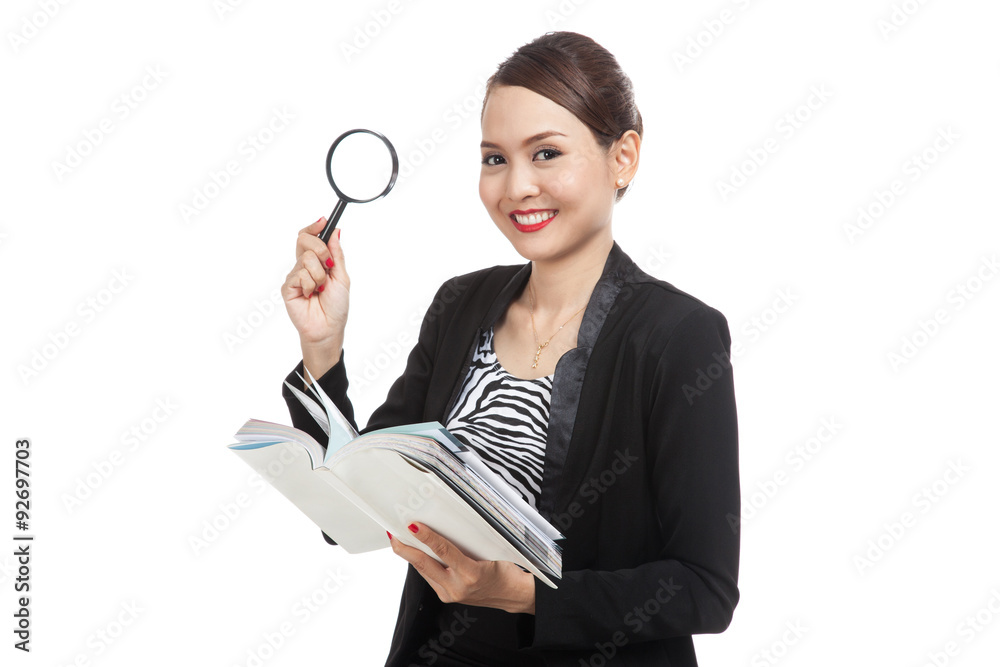 Asian business woman with a book and magnifying glass Asian business woman with a book and magnifying glass